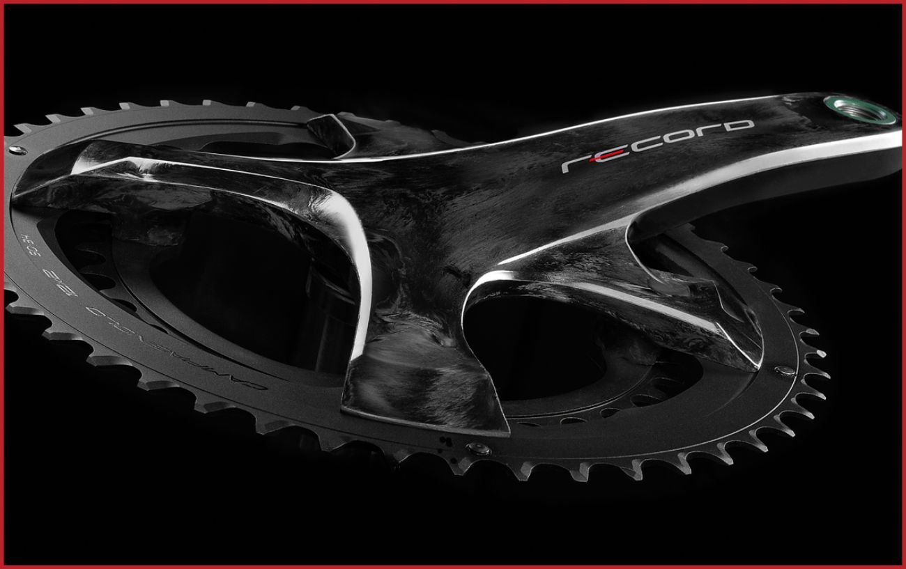 Campagnolo Record crankset on a black background.