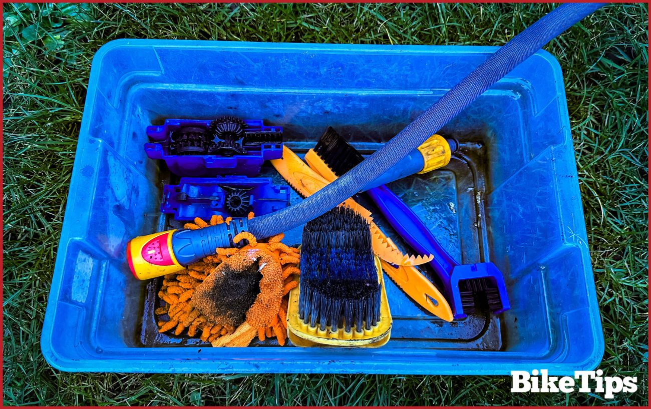 Bike cleaning products sat in a blue bucket.
