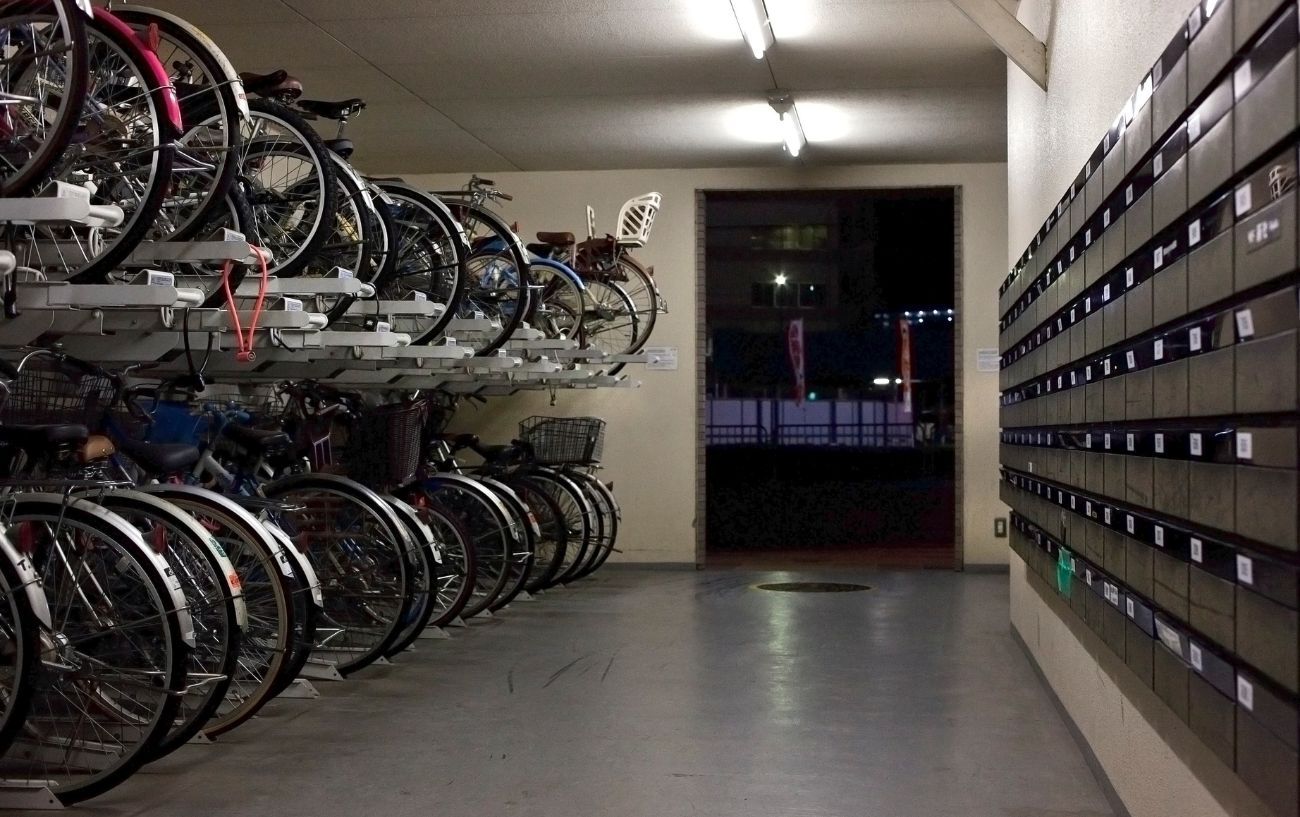 A bike storage room in an apartment block at night.