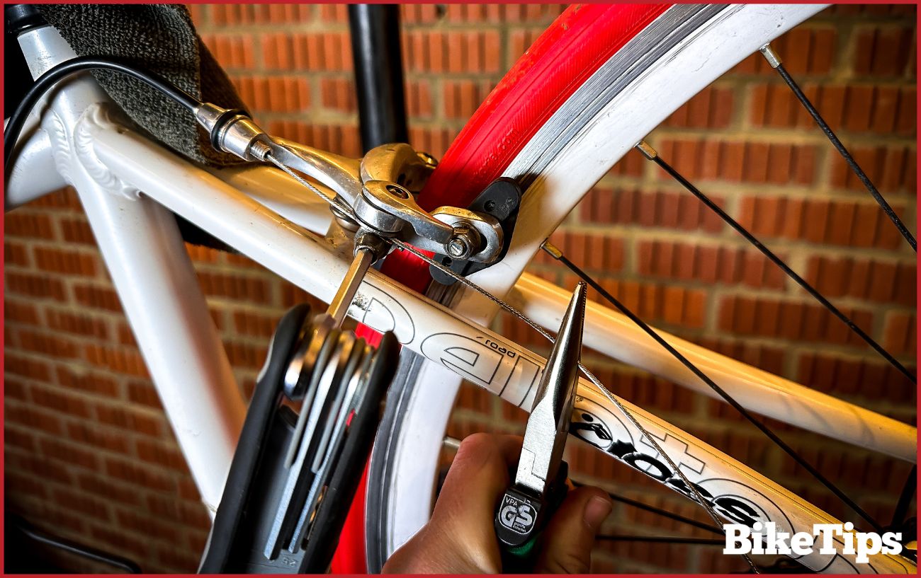 Attaching the new bike brake cable to the rear brake.