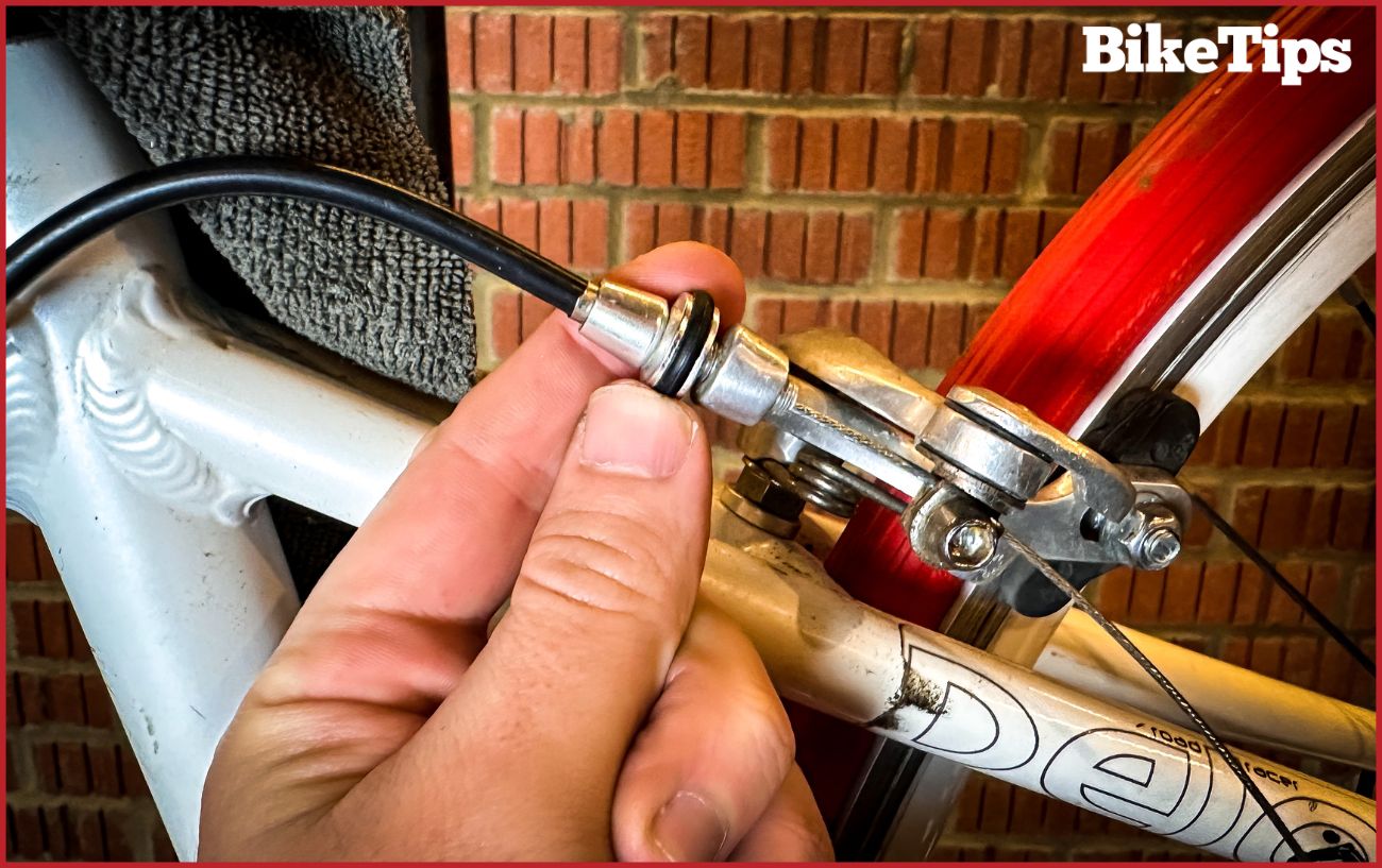 Turning the barrel adjuster to perfect the setup of the brakes.
