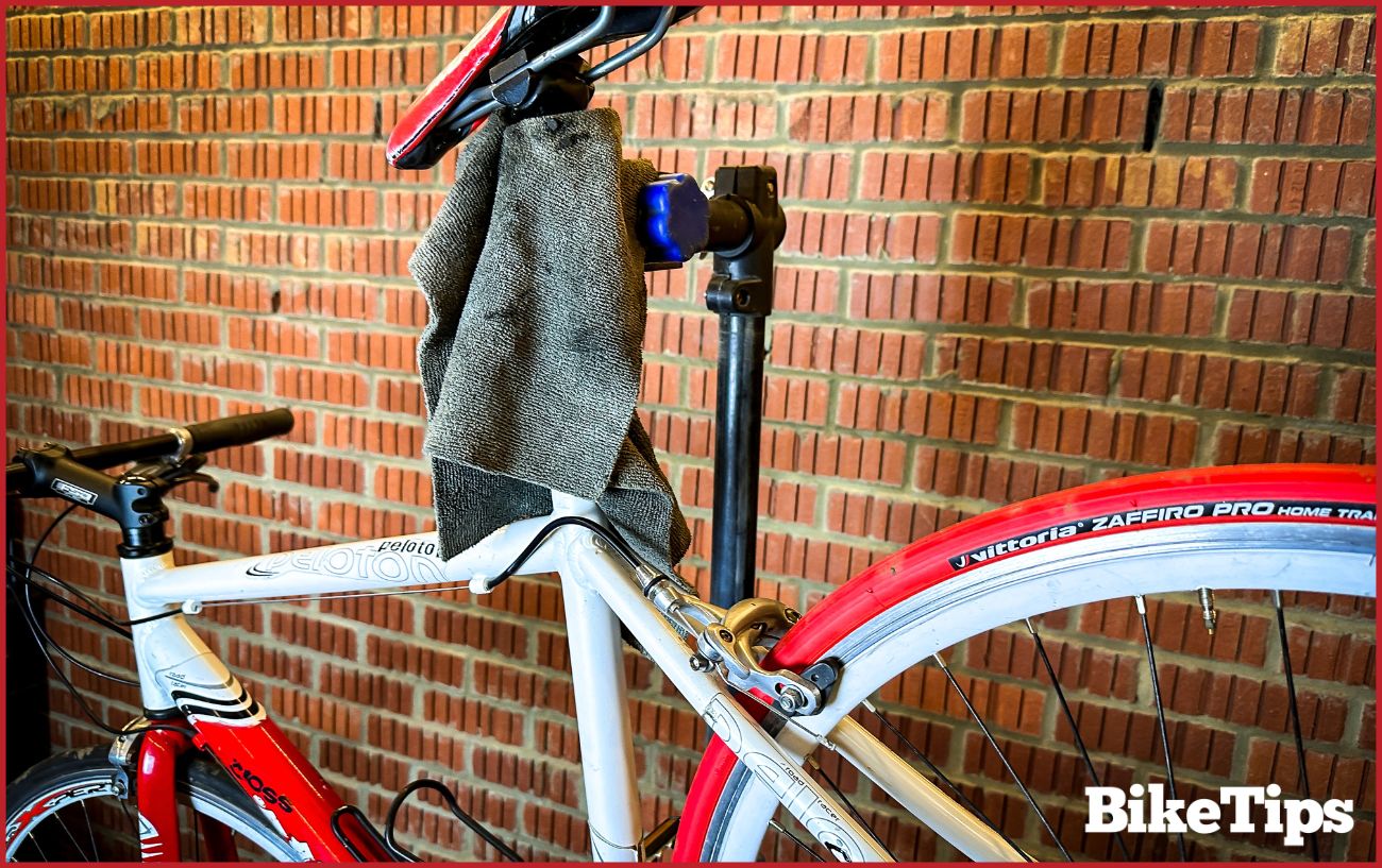 A bike is held in a maintenance stand, ready to be worked on.