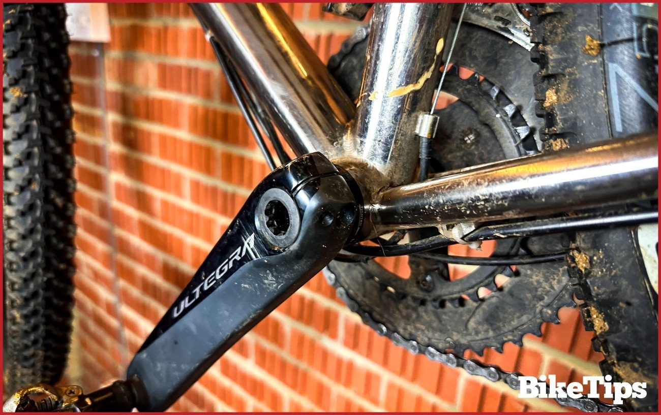 Close-up of a black bottom bracket on a bike.