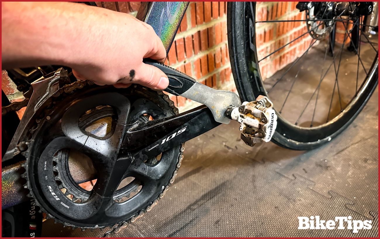 Removing the drive-side pedal from a bike.