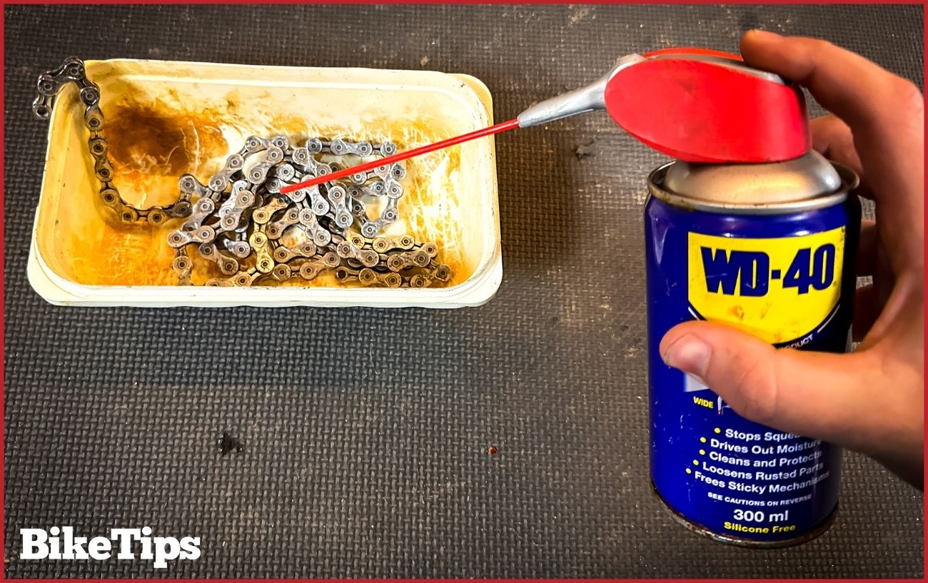 Removing rust from a bike chain using WD40.