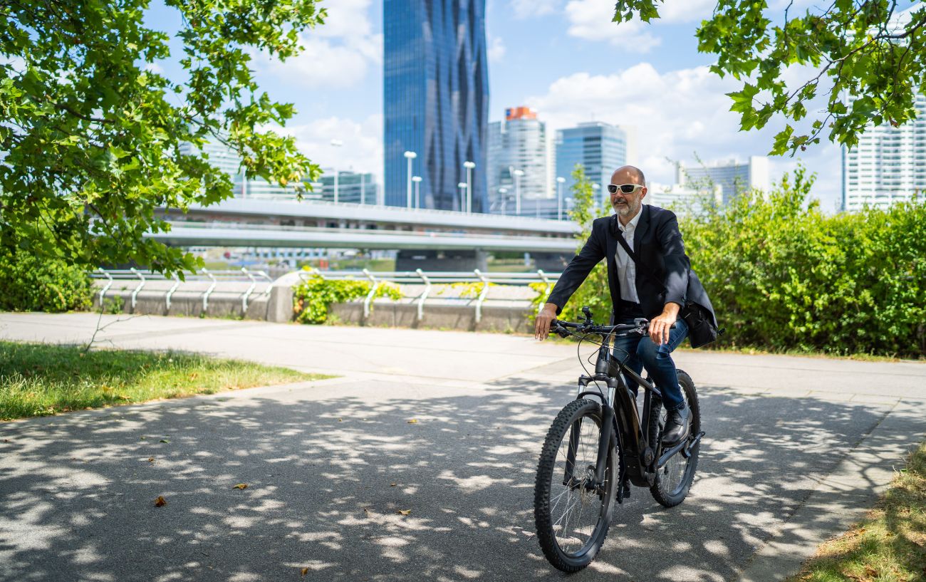 Man in a suit cycling to work on a hardtail mountain bike.
