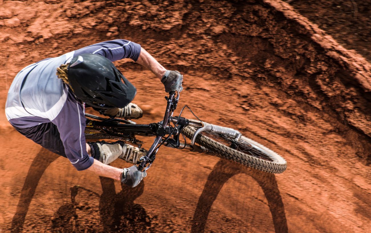 A mountain bike on a dirt trail, photographed from above.