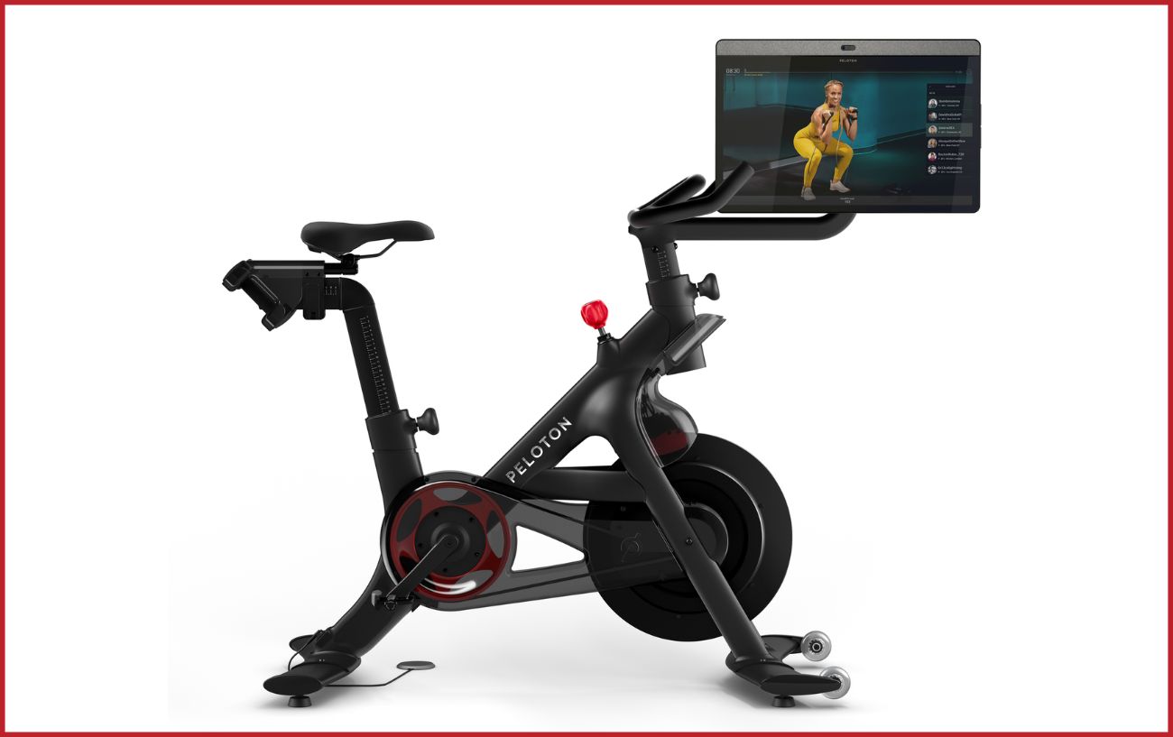 A Peloton indoor biycle with a white background.