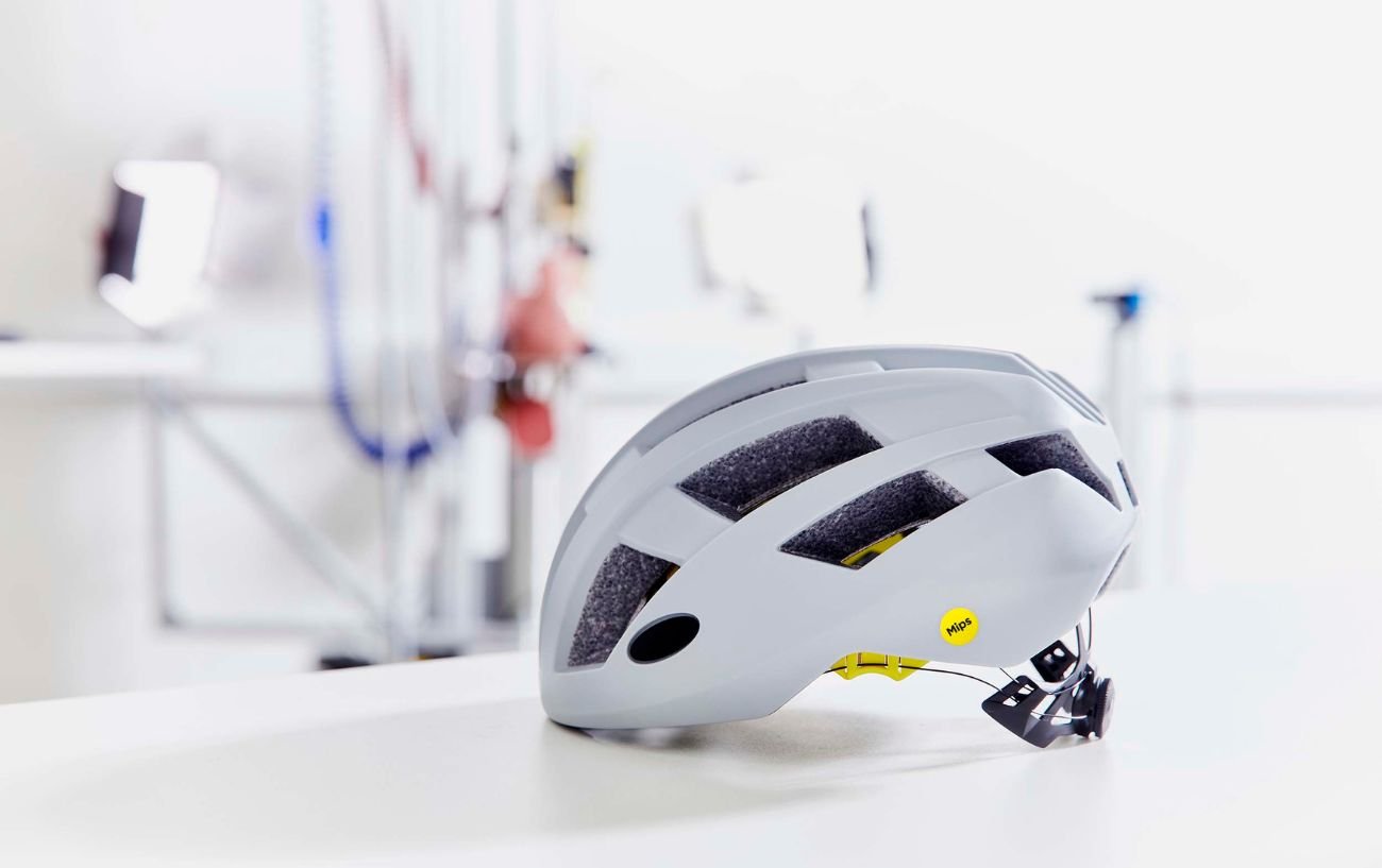 A MIPS helmet sits on a white table in a lab.