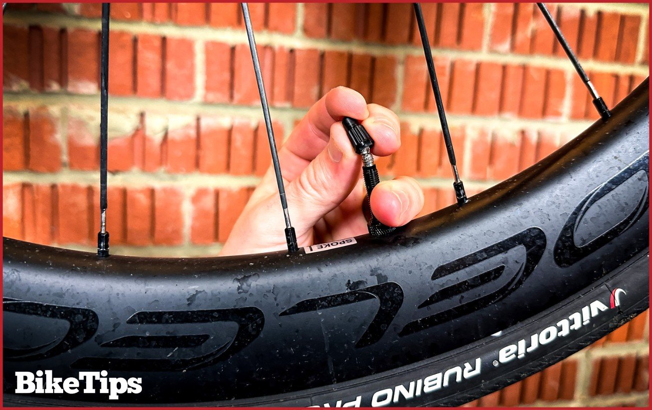 Screwing on a Presta valve cap.