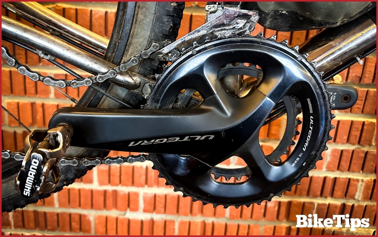 Photo of a black crankset with the chain hanging off.