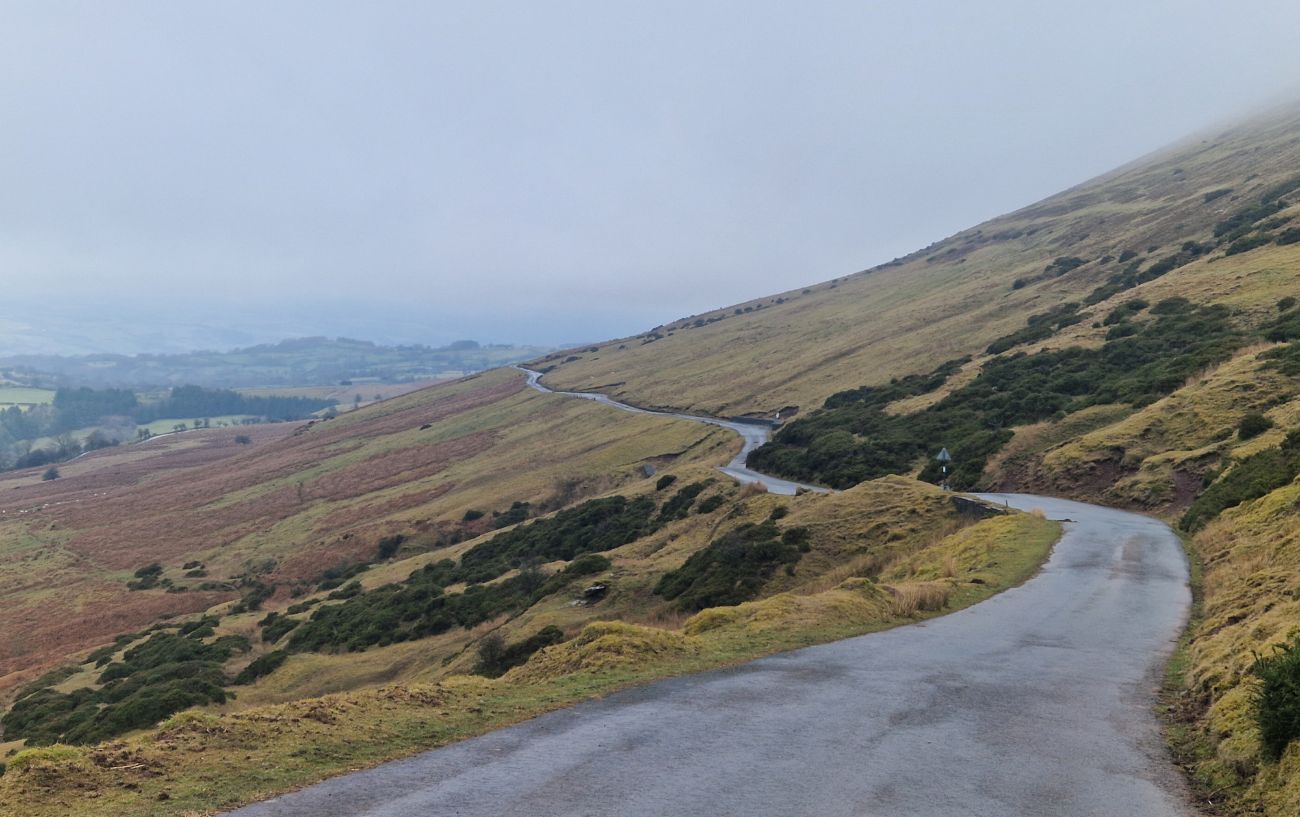 The climb rises up the hillside to the right.