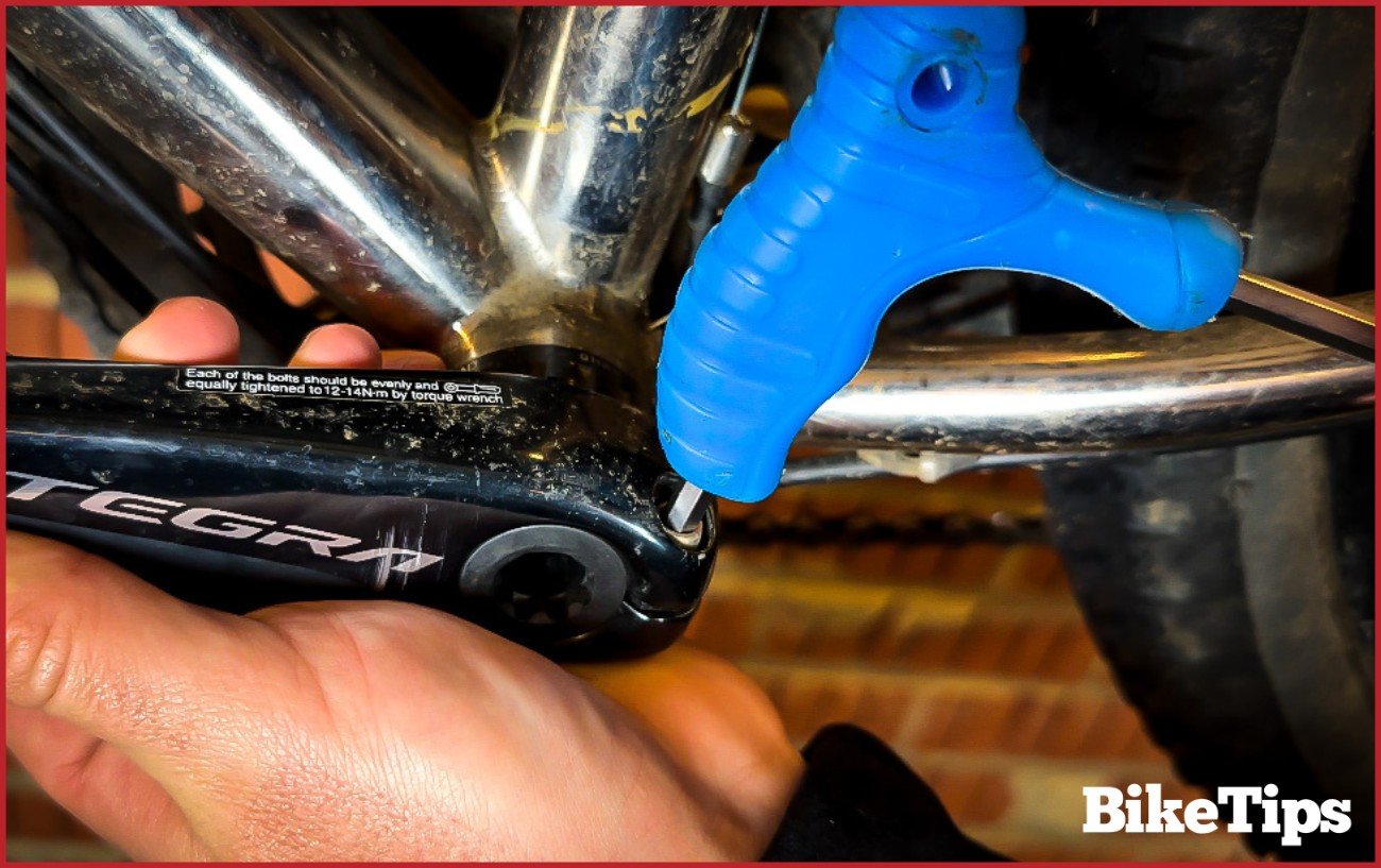 Using an Allen key to loosen a bike crank arm.