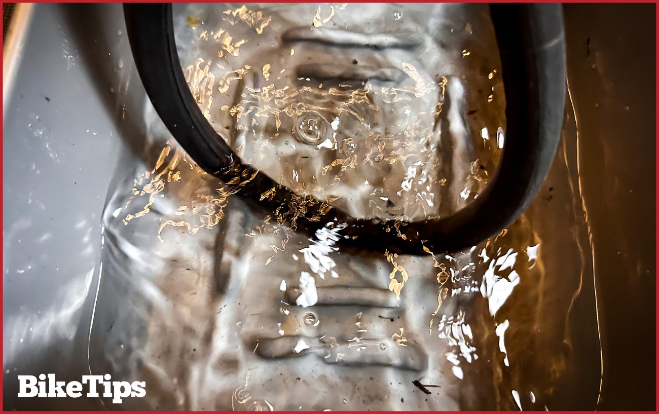Locating the puncture using a bucket of water.