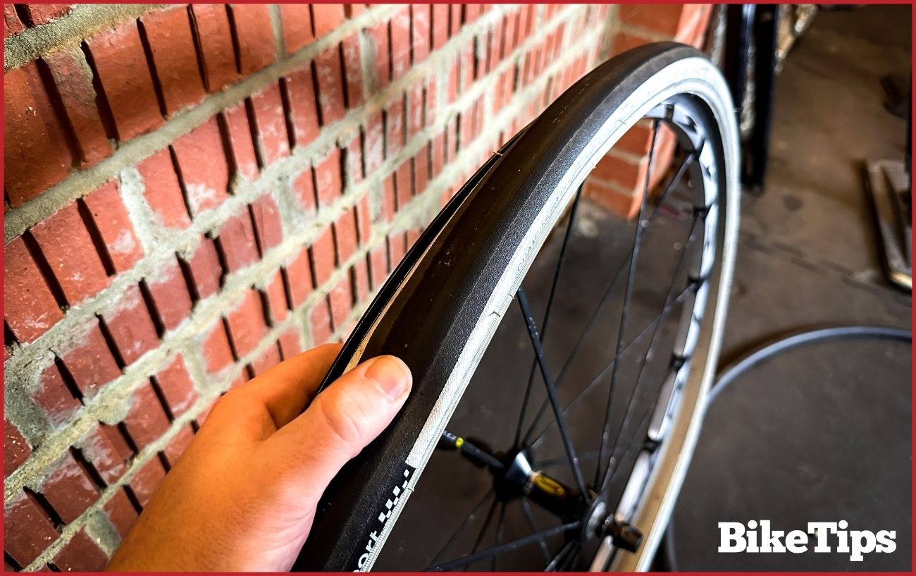 Inspecting the tire for any sharp objects.