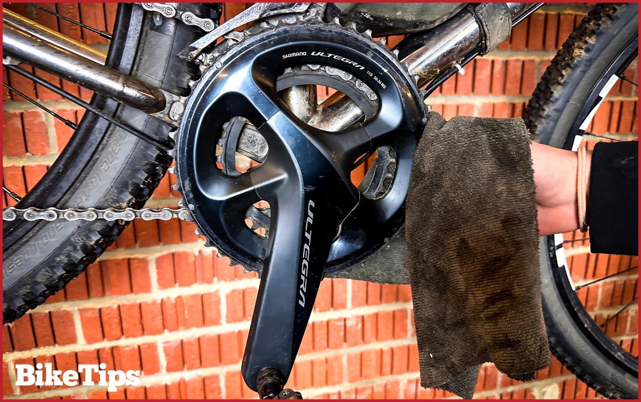 Using a rag to pull the chain off the chainrings.