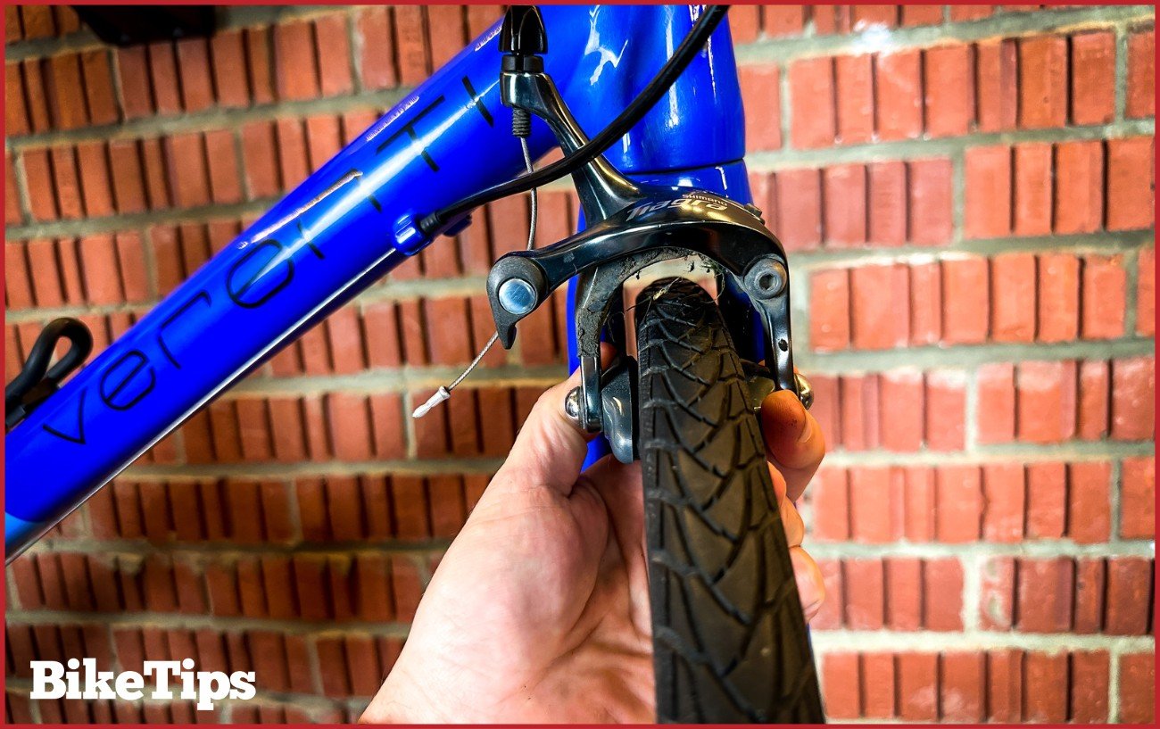 A Shimano Tiagra road bike rim brake being centralised.