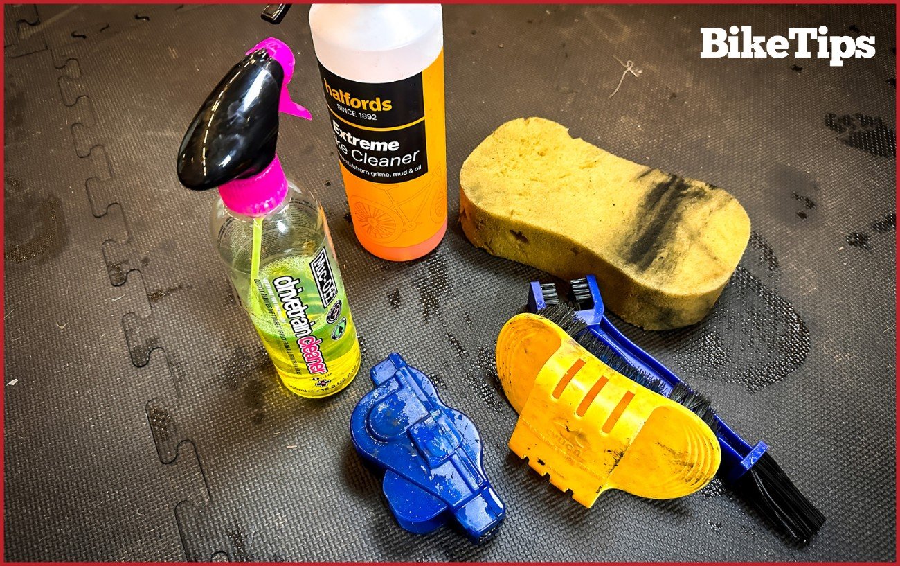 A cleaning kit for a bike consisting of sponge, bike wash, degreaser, brushes, and chain cleaner.