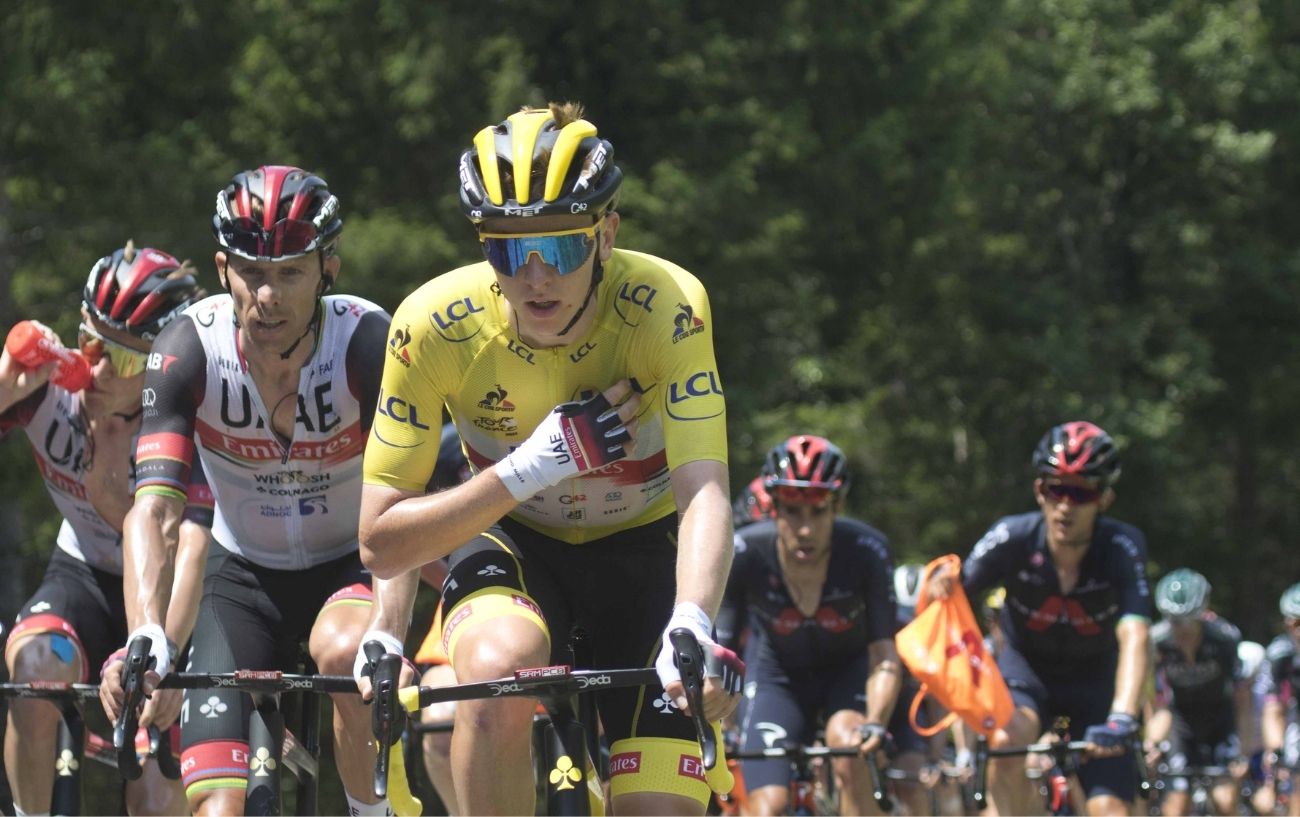 Tadej Pogačar wearing yellow in the peloton on Stage 14 of the 2021 Tour de France.