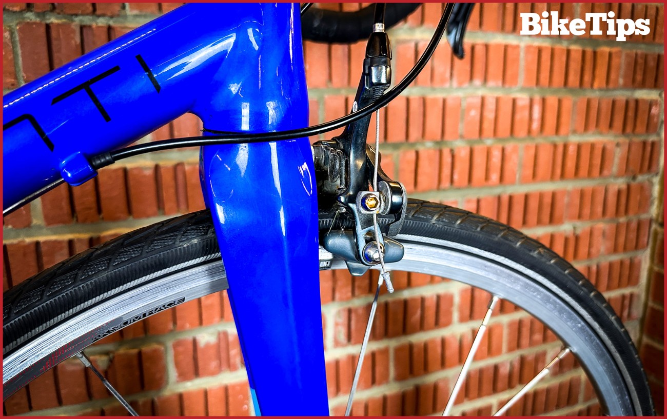 A Shimano Tiagra rim brake on a road racing bike front fork.