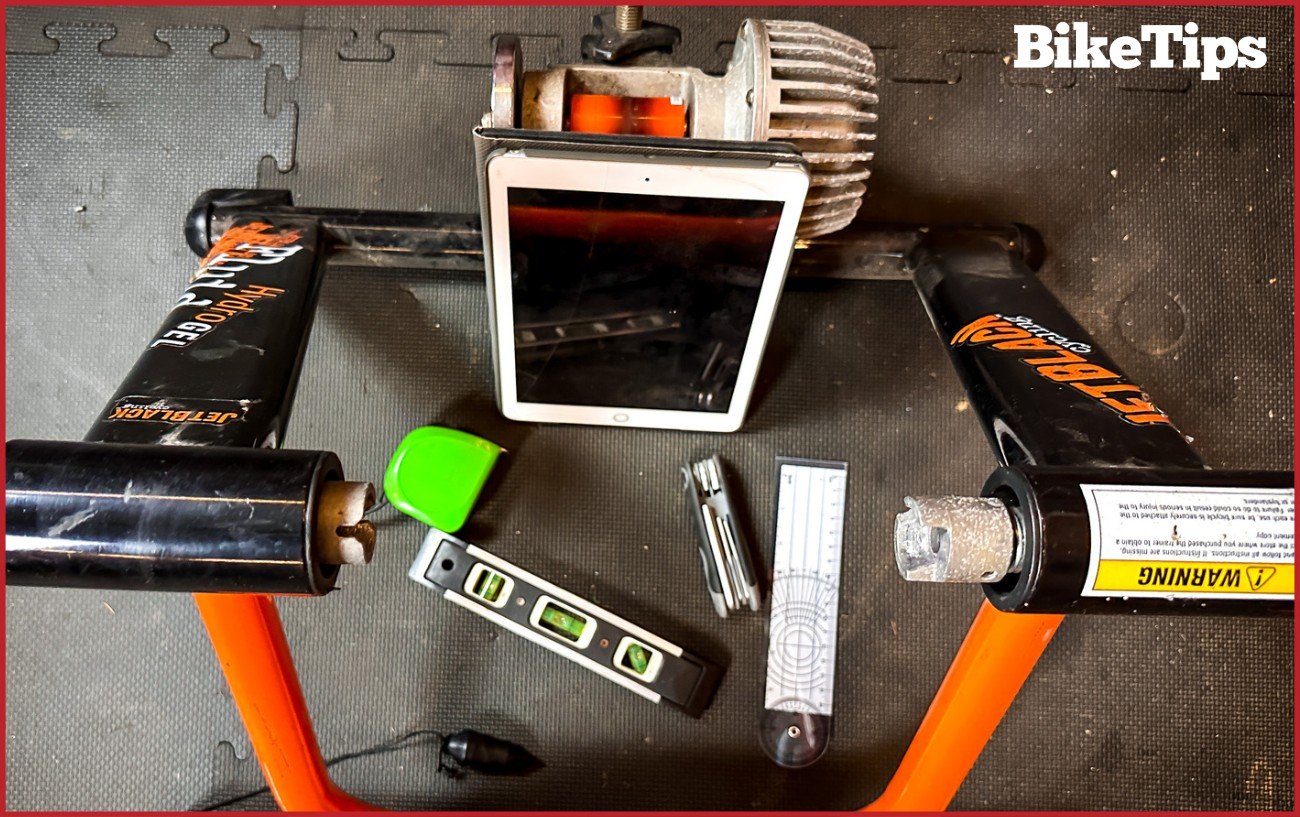 The tools you will need to adjust your saddle properly. A turbo trainer, tape measure, ruler, plumb line, Allen key, a level, and an iPad.