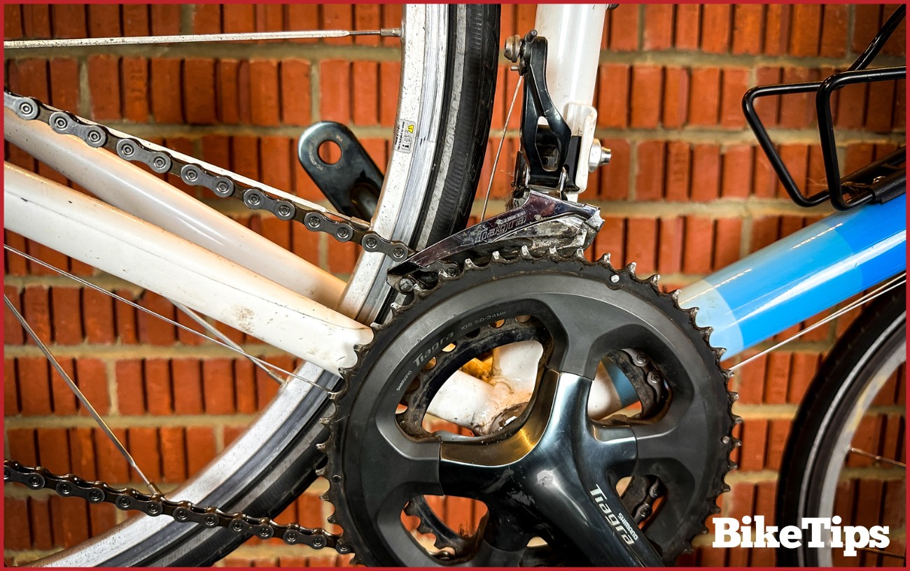 A bikes drivetrain focusing on the crankset and the front derailleur.