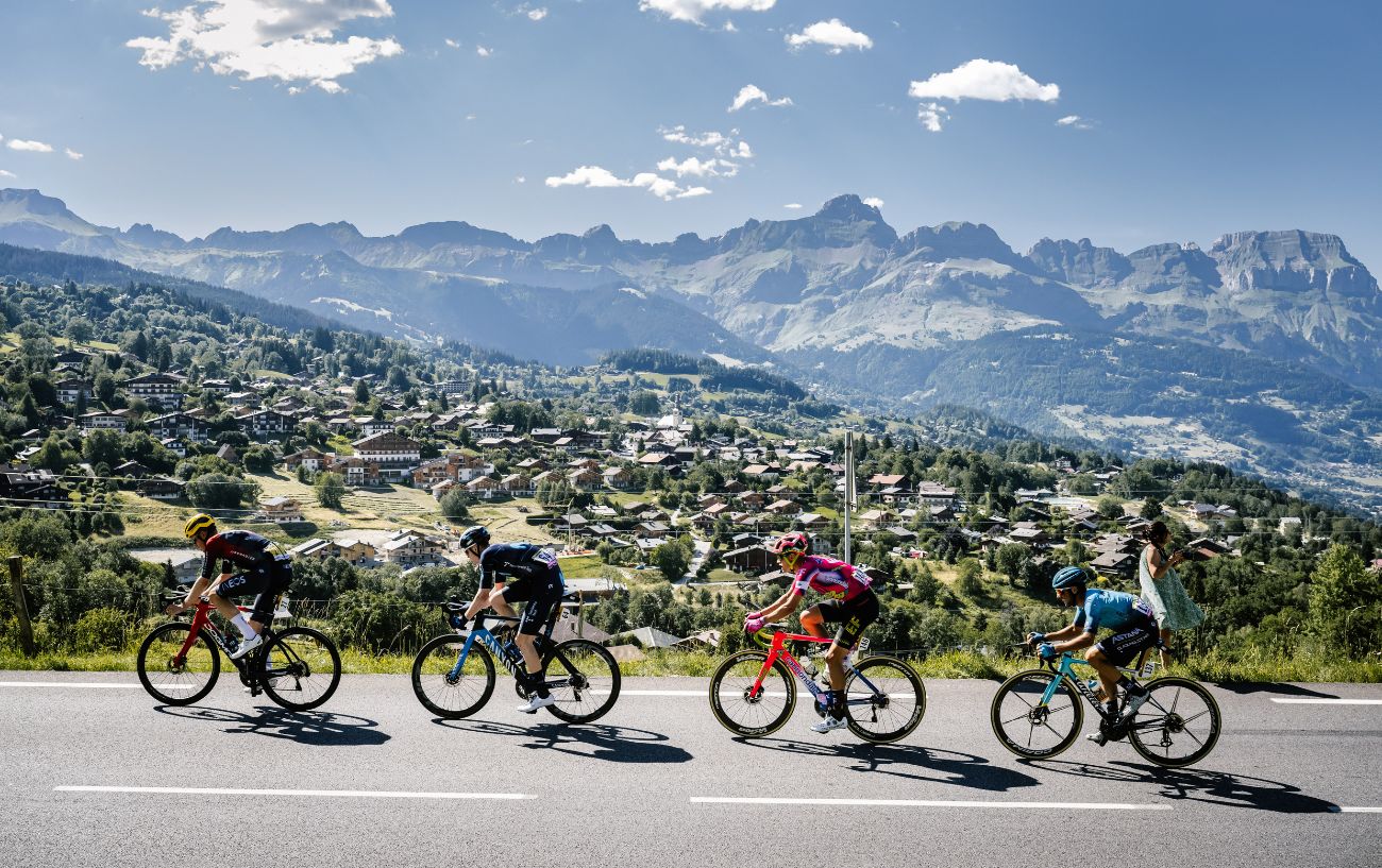 Cyclists in the Alps with a mountainous backdrop at the 2022 Tour de France.