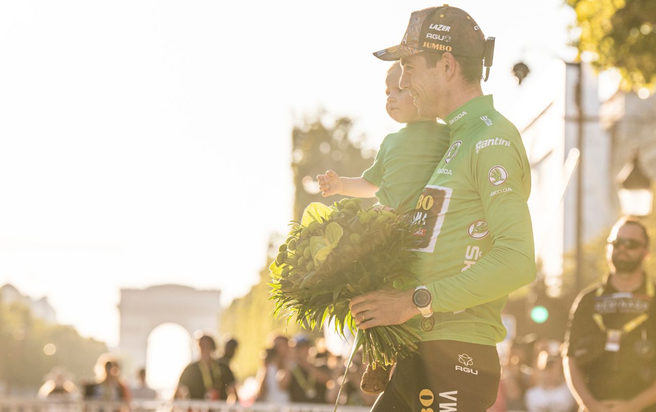 A cyclist wears the green sprinter's jersey at the end of the Tour de France.
