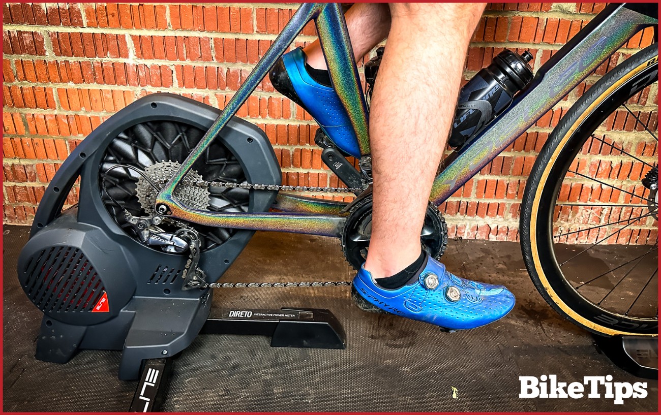 Close up of a smart turbo trainer with a cyclist on.