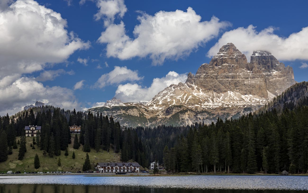 View of the Tre Cime di Lavaredo across a lake.