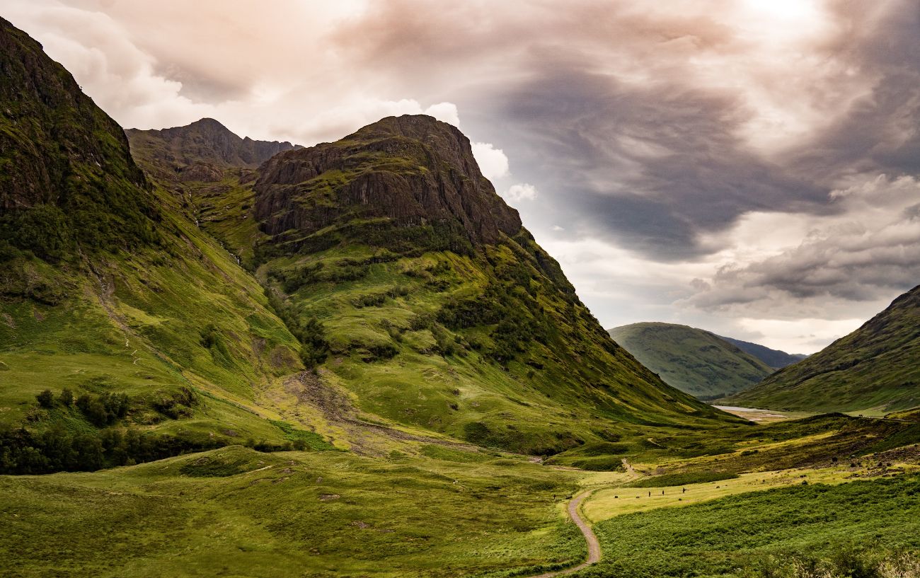 A small road cuts through the Scottish cliffs.