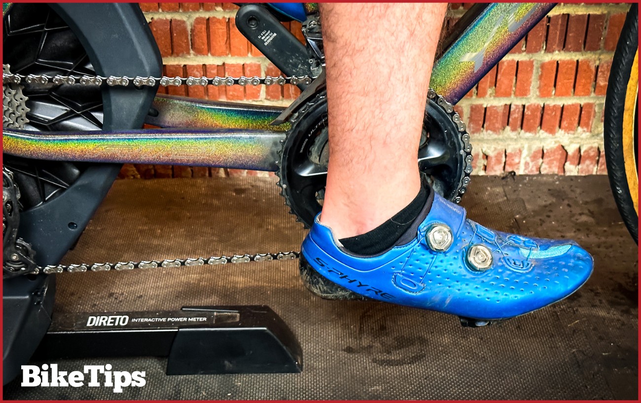 Close up of a foot on a turbo trainer.
