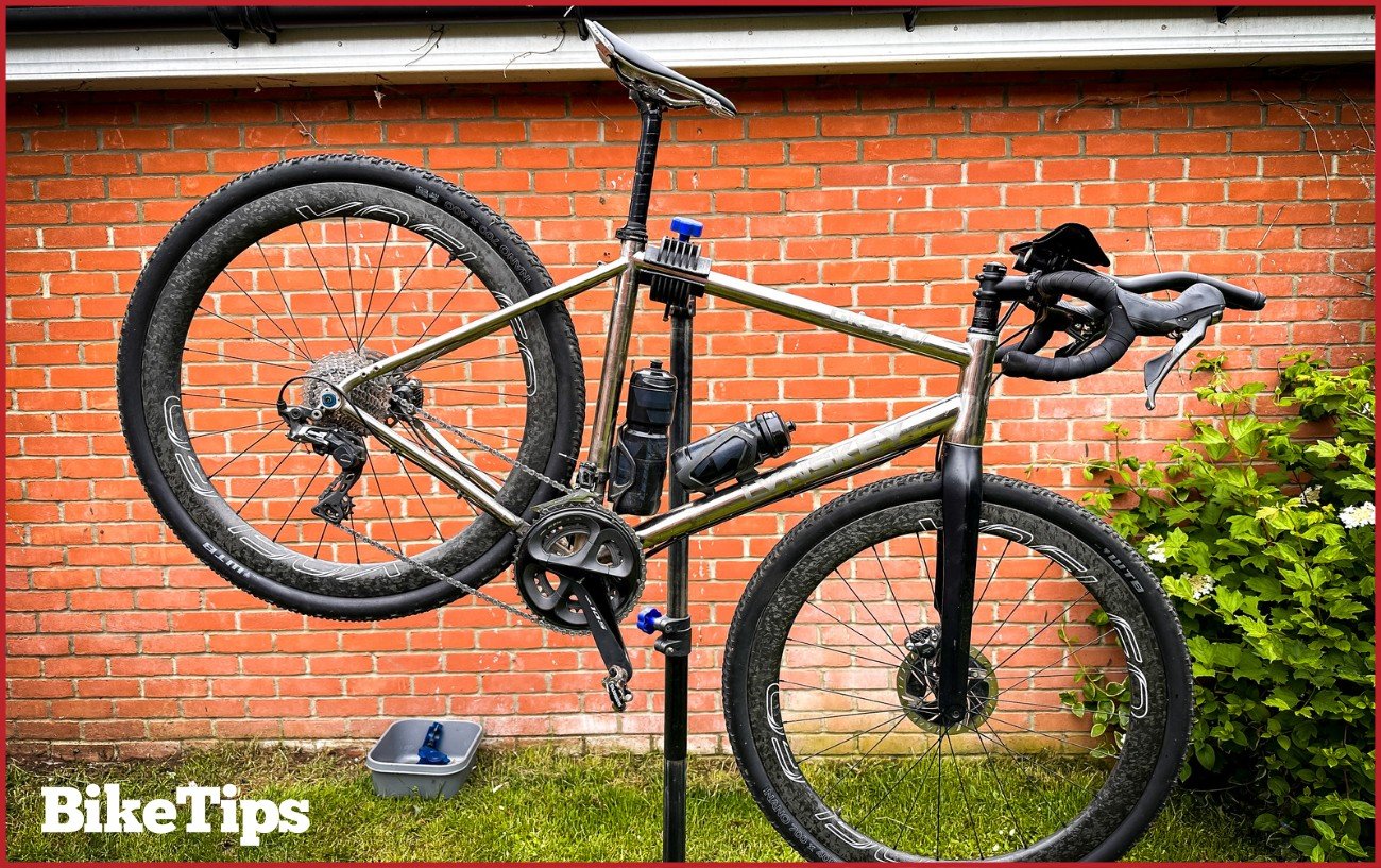 A gravel bike sitting in a stand about to be cleaned. 