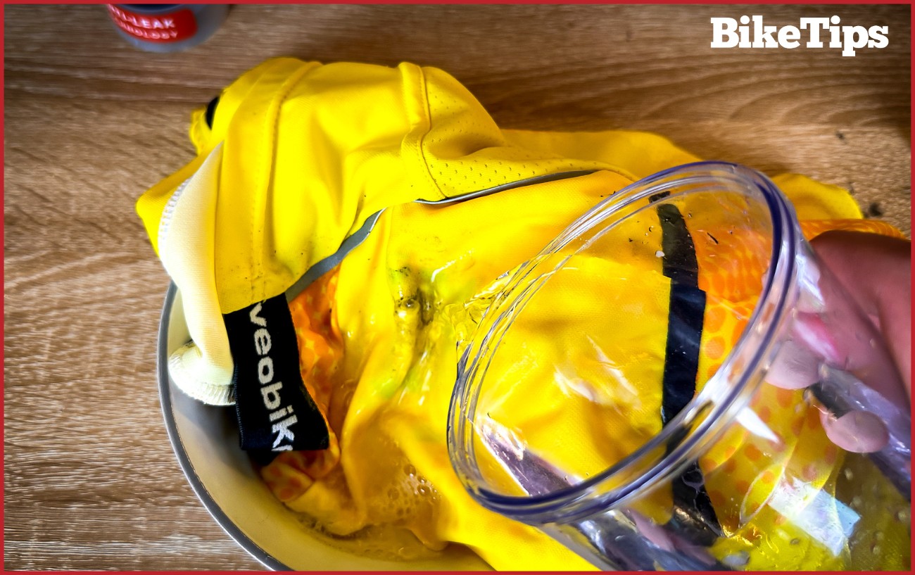 Rinsing dishwashing liquid off a bike jersey in a bowl.