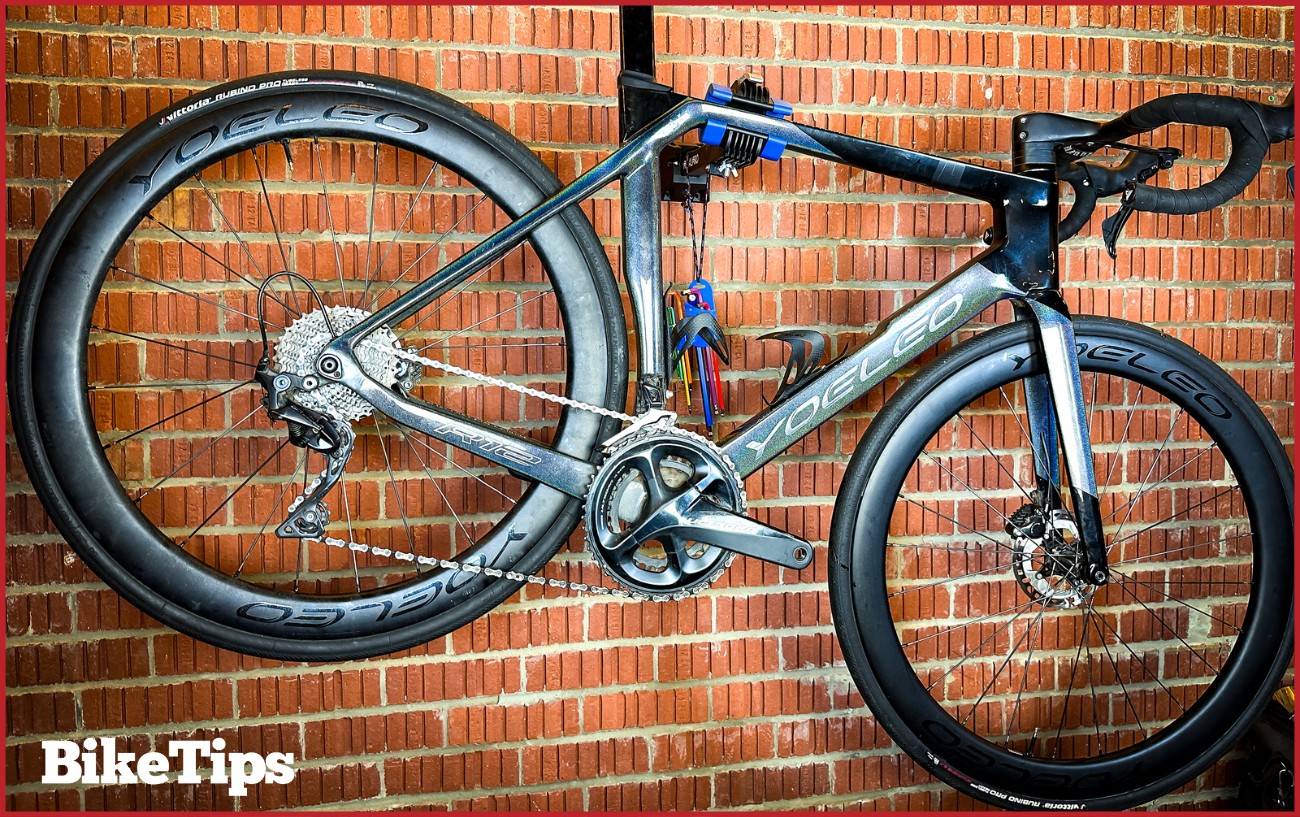 A Yoeleo R12 road bike in a wall stand.