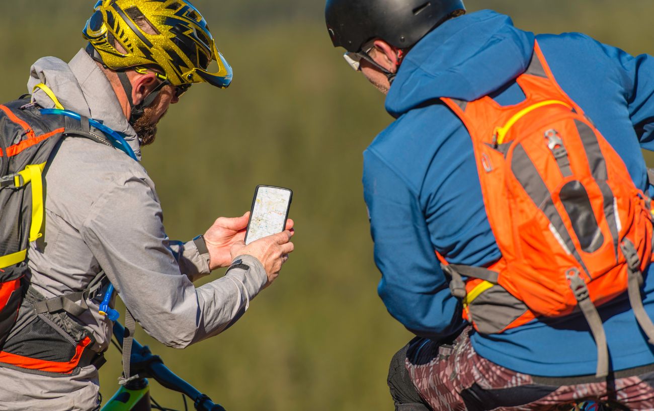 Two cyclists pause to check their GPS app.