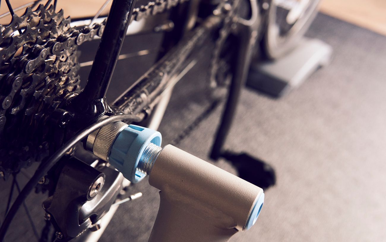 An indoor cycling trainer with the trainer attached to the rear wheel. 