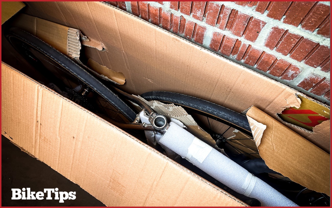 A bike is packed into a bike box, ready for a triathlon race.