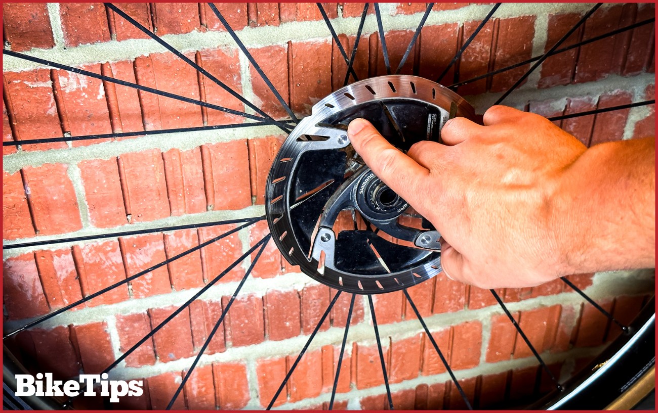 Inspecting a disc brake rotor.