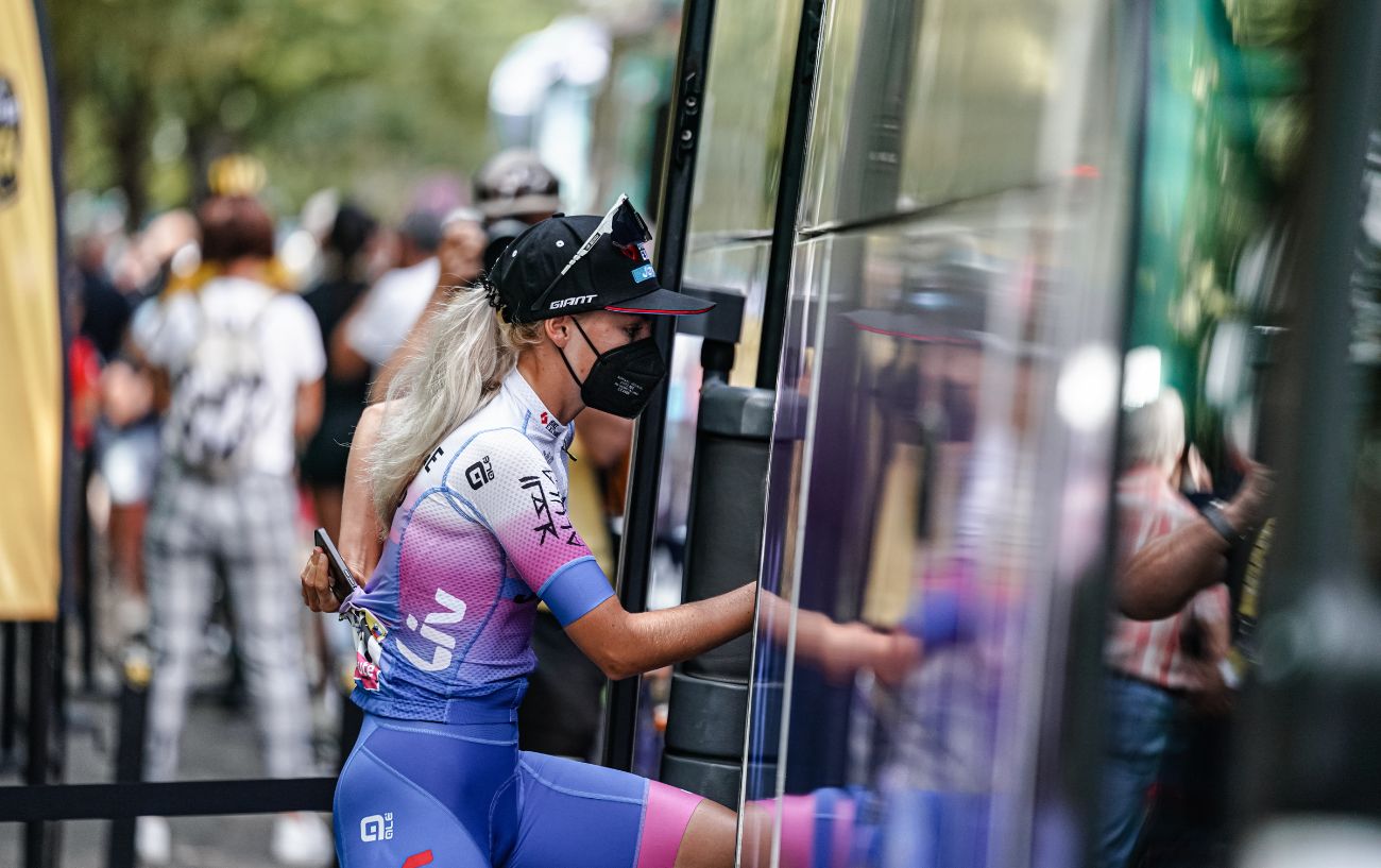 A Tour de France rider boards the team bus at the end of a stage.