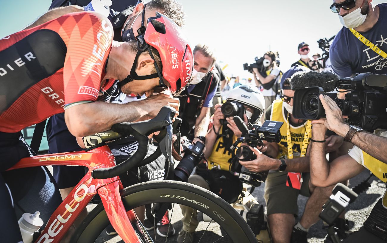 Michał Kwiatkowski slumps over his handlebars after winning Stage 13 of the 2023 Tour de France.