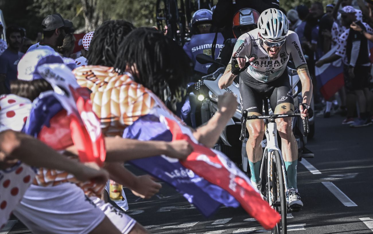 Wout Poels celebrates on the bike as he nears the finish line.