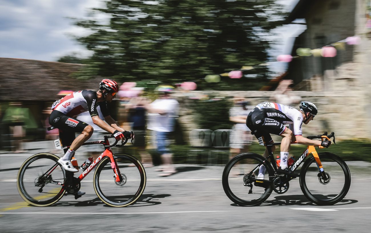 Matej Mohoric flies away from a rival in an aerodynamic riding position.