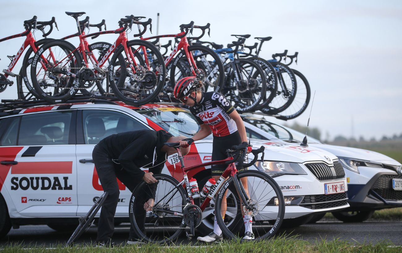 A bike mechanic replaces the rear wheel of a Tour de France bike during a race.