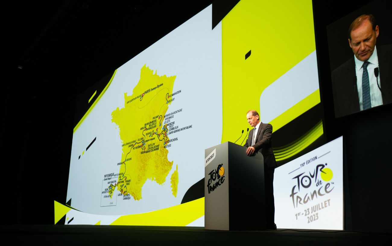 Christian Prudhomme speaks onstage at the Tour de France 2023 announcement event.