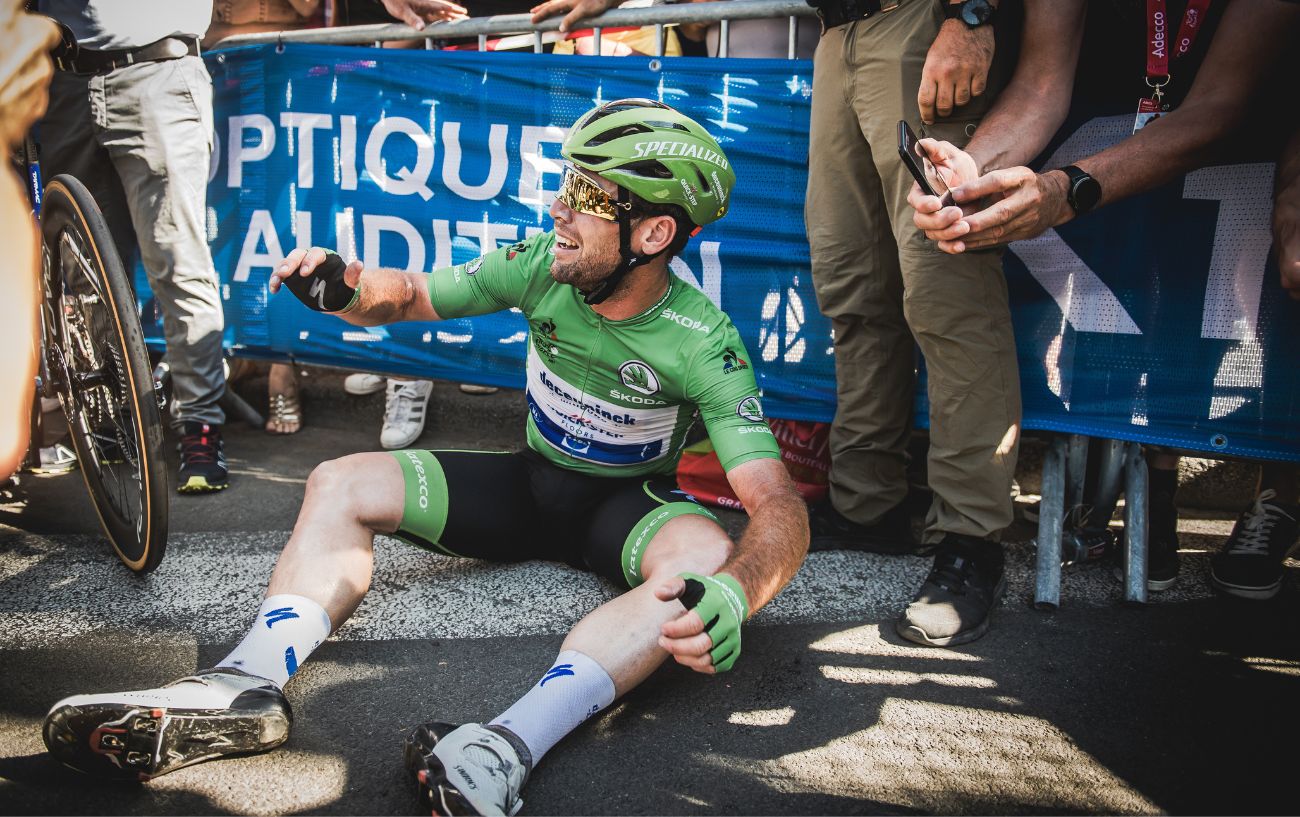 Mark Cavendish sits on the floor after winning a stage at the 2021 Tour de France.