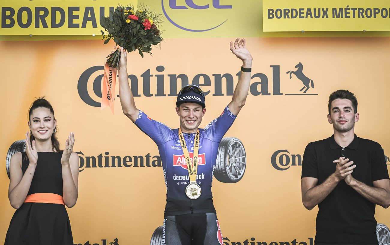 Jasper Philipsen stands on the podium after winning Stage 7 of the 2023 Tour de France.