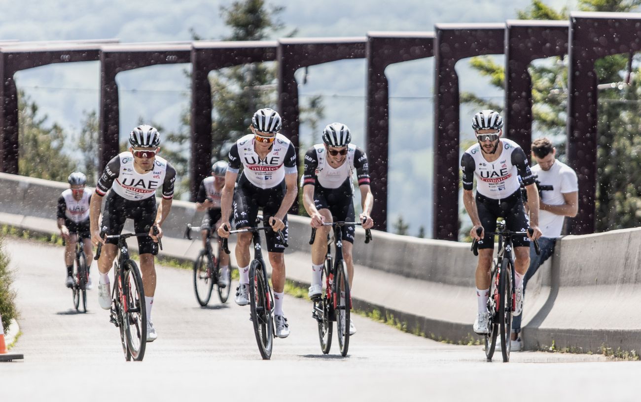 A cycling team climb a hill on a recovery ride.