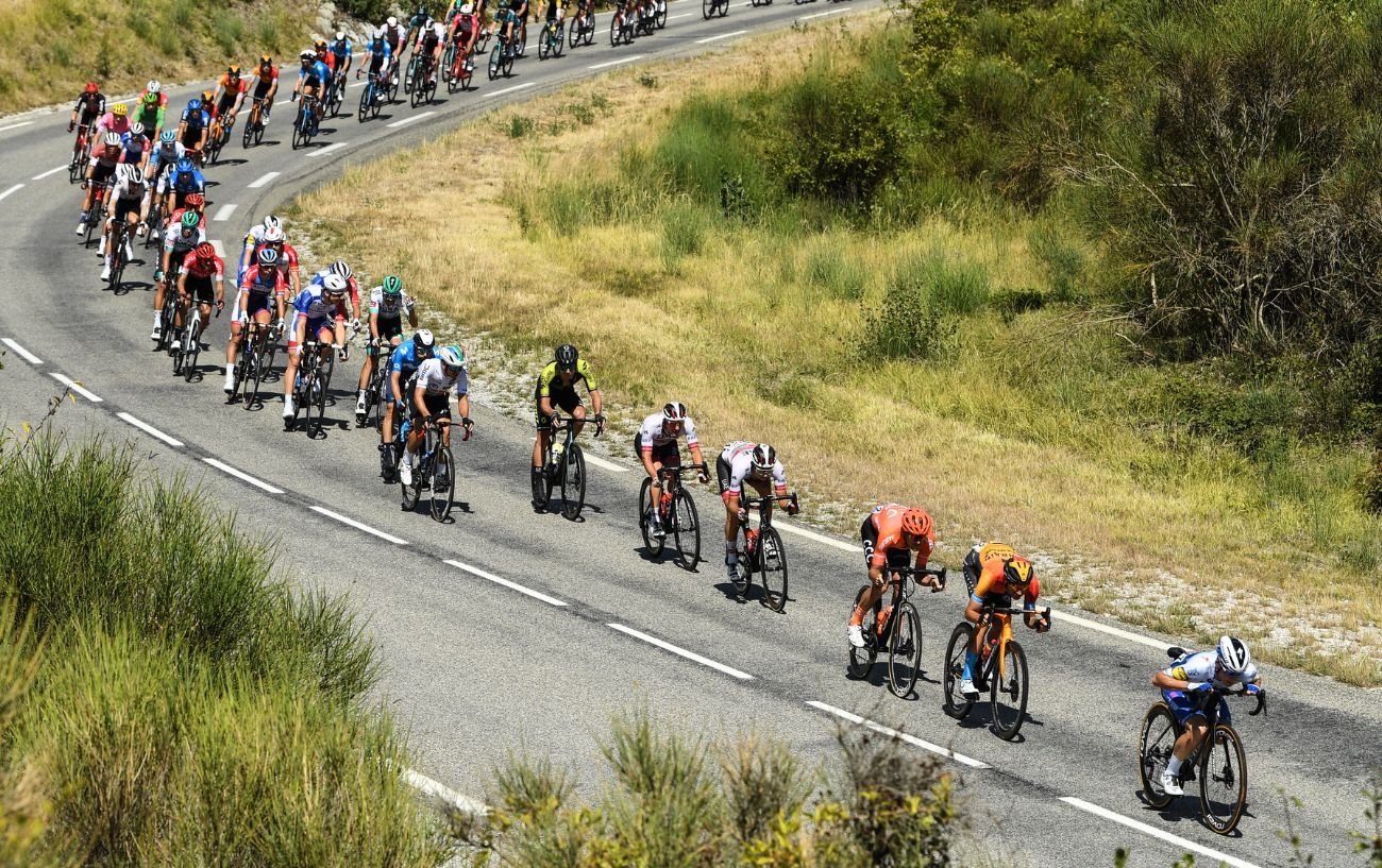 The peloton races downhill, contributing the the breakneck Tour de France average speeds set in recent years.