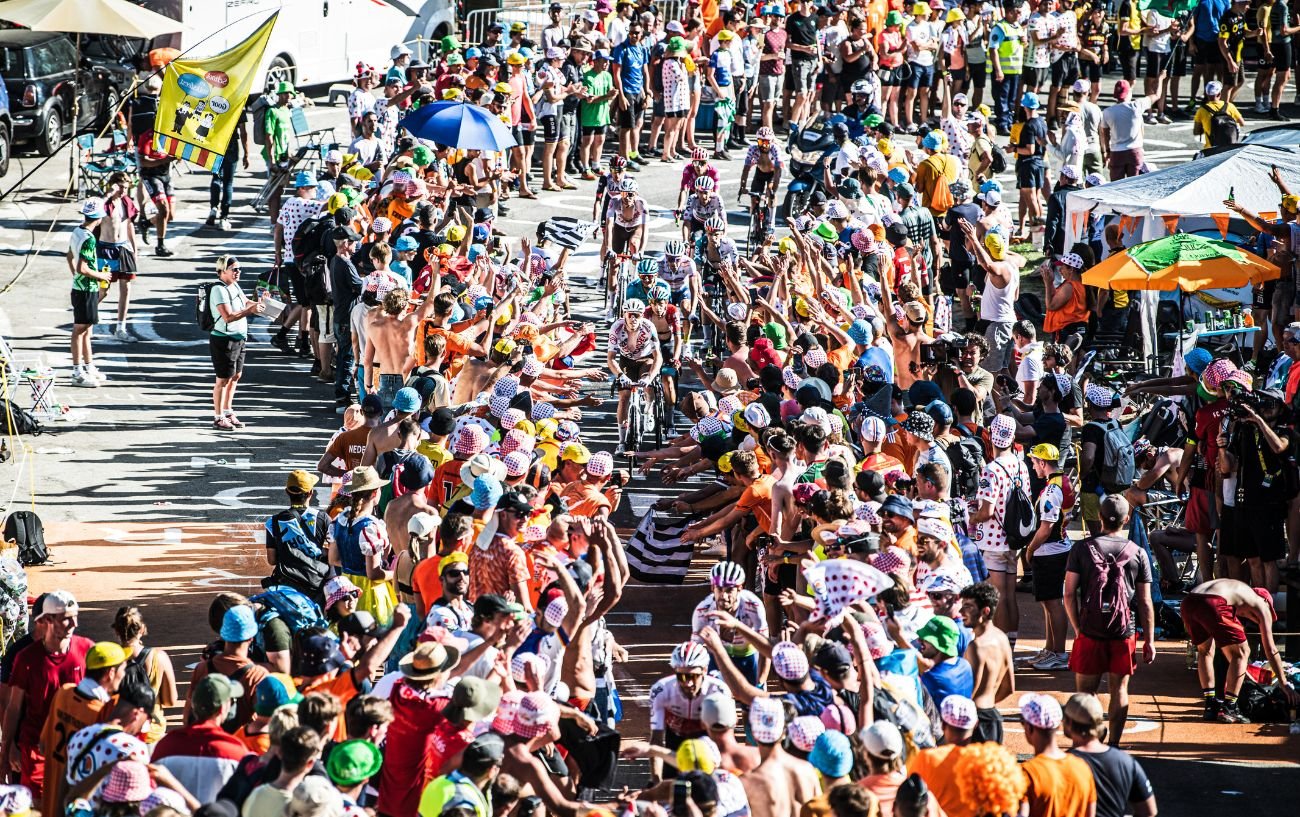 The Tour de France climbs up Alpe d'Huez with fans lining the road.